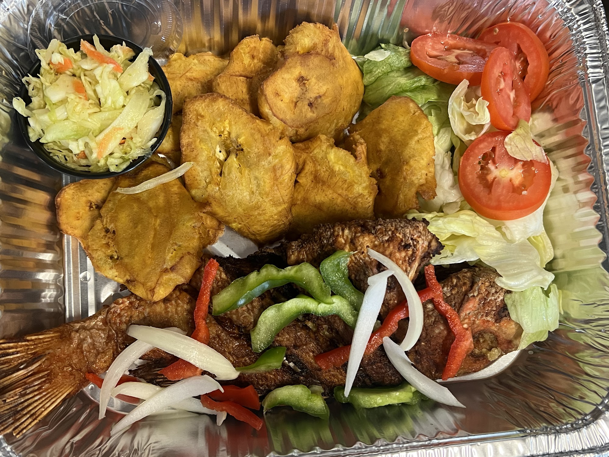 Family tray with plantain, salad and fried meat